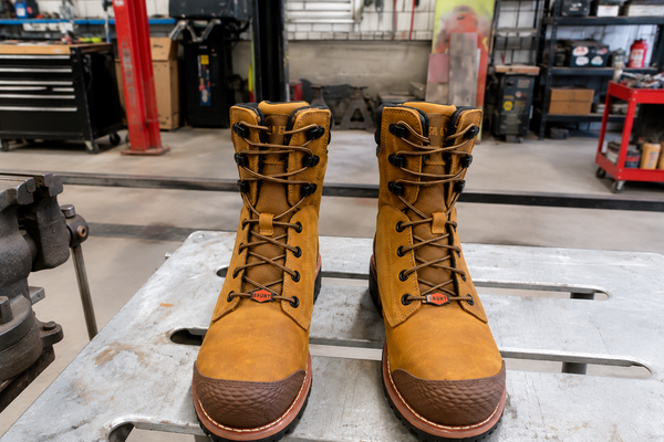 BRUNT DiStasio composite toe work boots on a workbench in an automotive restoration and fabrication shop