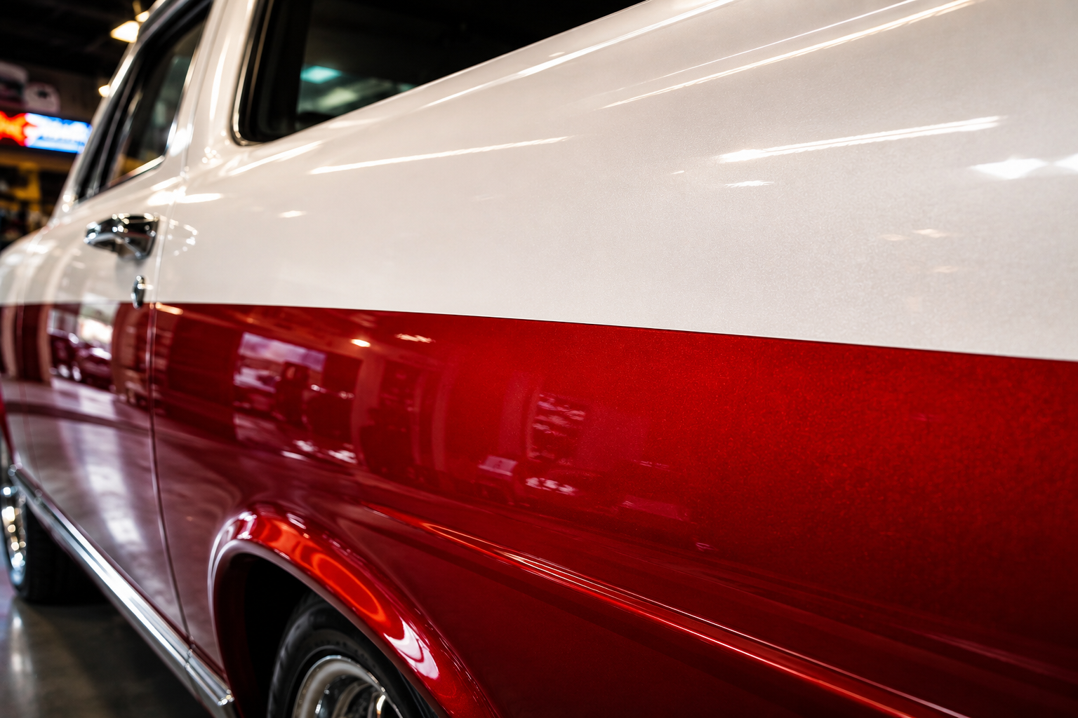 2 tone truck paint with crisp separation line between white and metallic red, showing high gloss reflection and clean edge on bedside panel