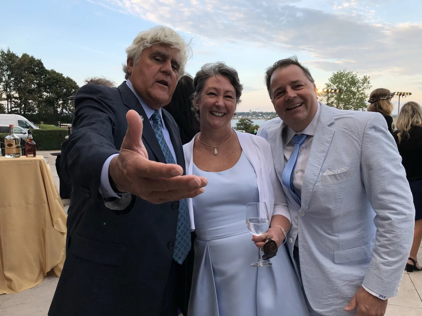 Troy Kane and his wife with Jay Leno at an automotive event.